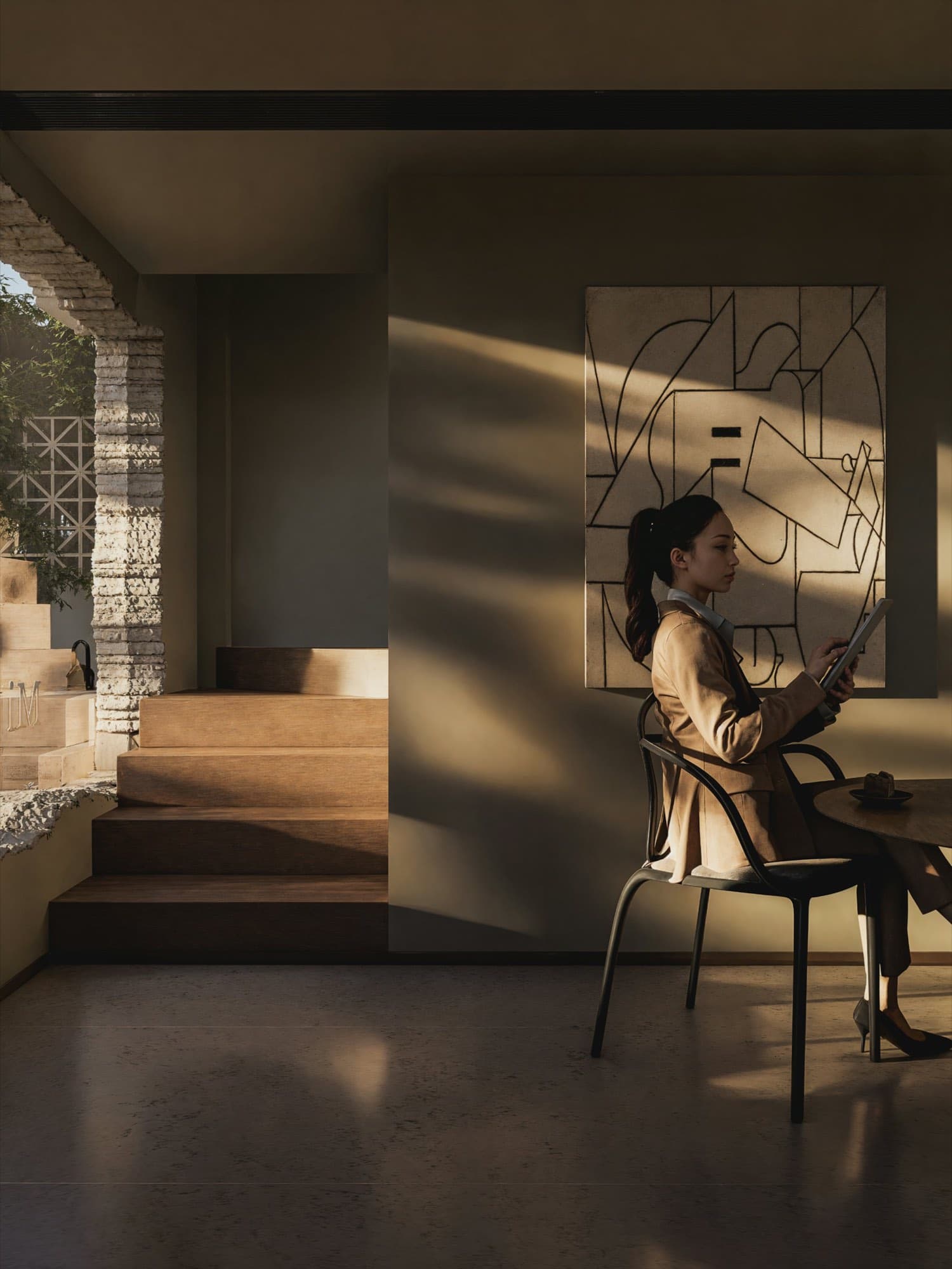 A quiet room with morning light across a bed and a desk