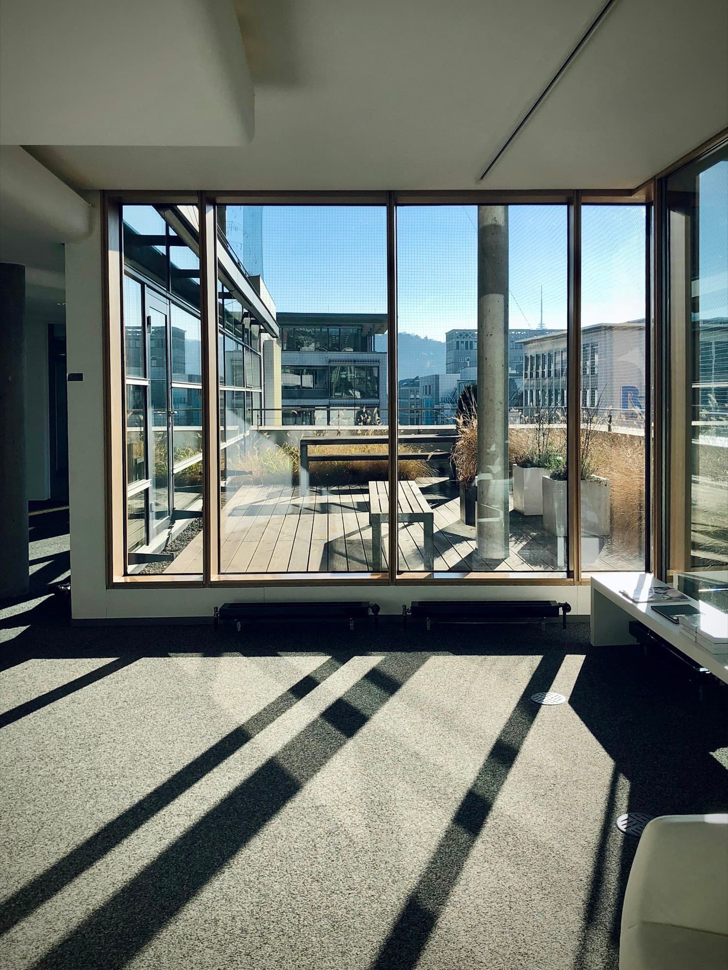A meeting room with a long table and a view over the city