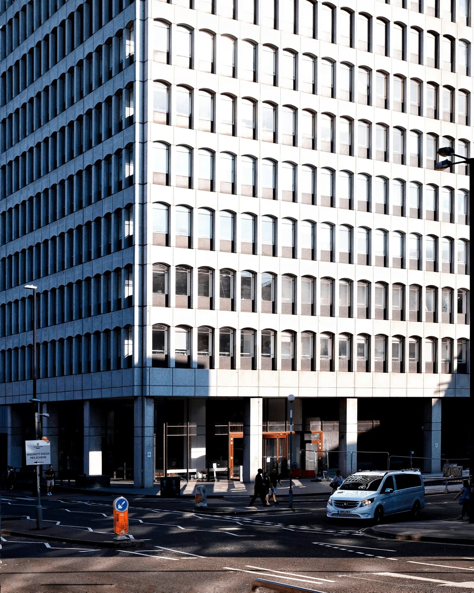 A repeating grid of windows across a modernist facade